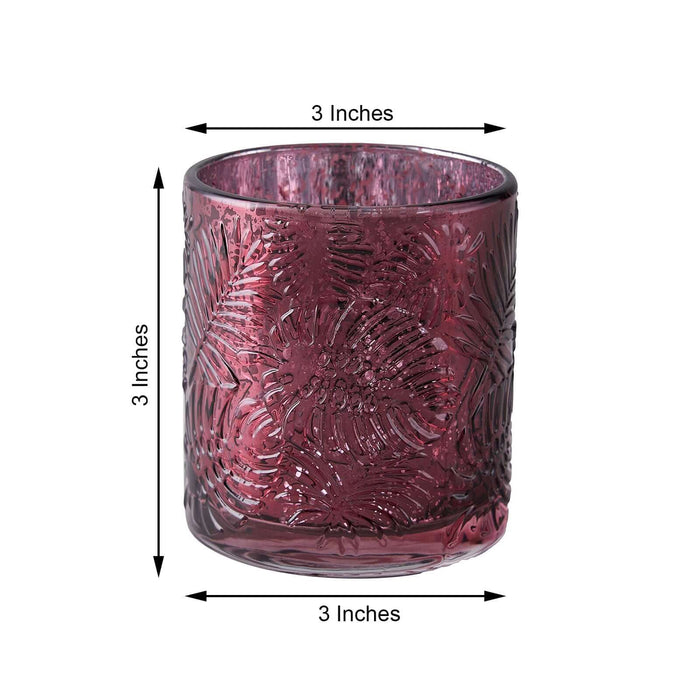 Decorative pink glass candle holder, 3 inches in height and width.