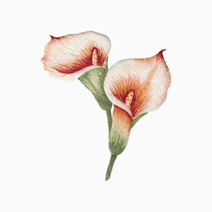 Hand embroidered cotton towel with two pink and orange calla lilies on a white background