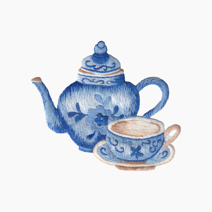 Hand embroidered cotton towel with blue teapot and cup with traditional floral patterns on a white background